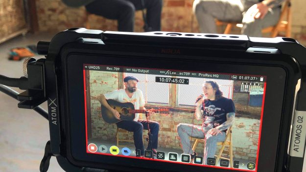 An Image of A Video Camera Recording A Music Video For A Band